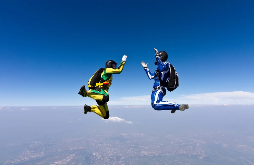 two-skydivers-falling-from-the-sky-with-black-parachute