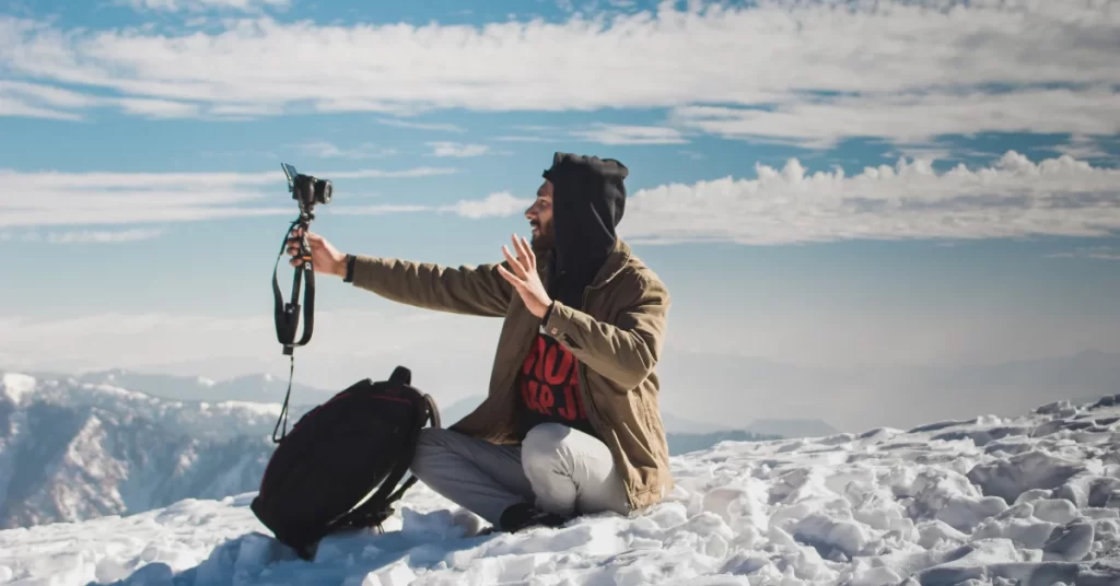 man-taking-a-video-of-himself-on-a-snow-mountain
