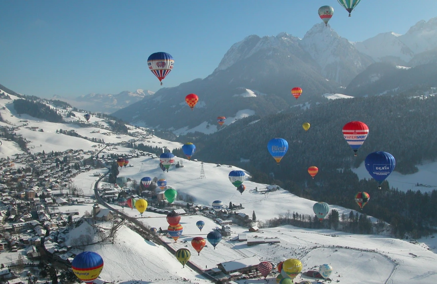 Air ballons floating top of ice mountains