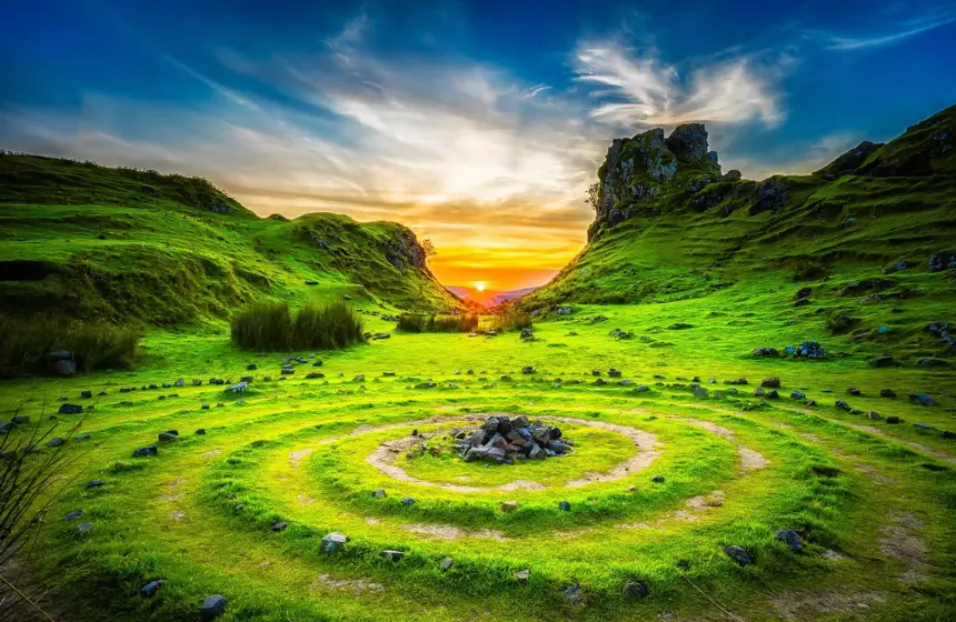 beautiful sunset view from a mountain filled with green plants in the ground